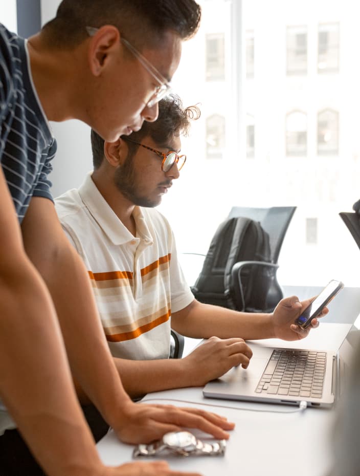 People working around a computer