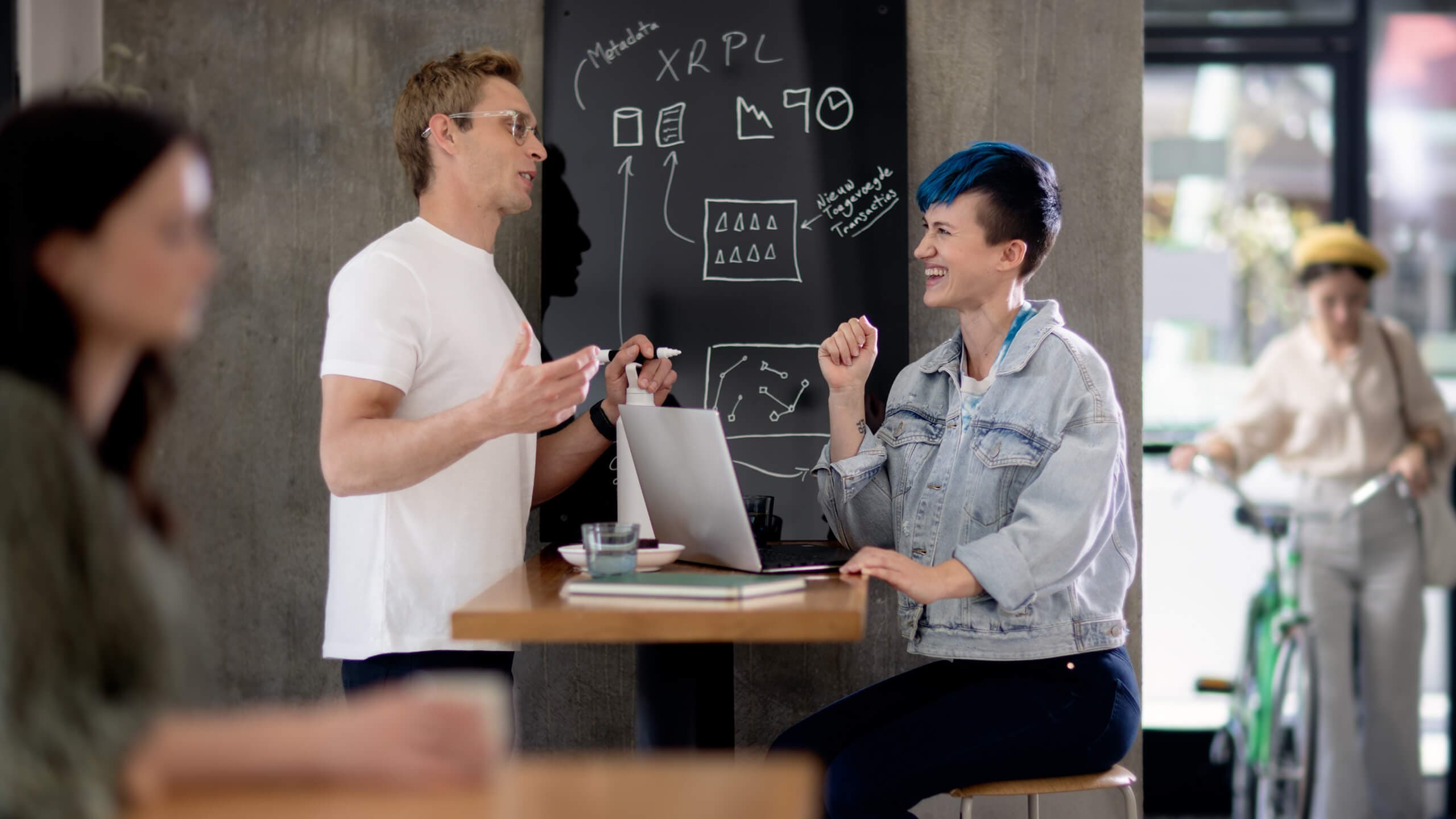 Boy and girl smiling at laptops